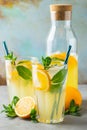 Two glass with lemonade or mojito cocktail with lemon and mint, cold refreshing drink or beverage with ice on rustic blue Royalty Free Stock Photo