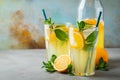 Two glass with lemonade or mojito cocktail with lemon and mint, cold refreshing drink or beverage with ice on rustic blue Royalty Free Stock Photo