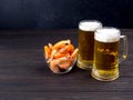 two Glass mug of light beer and fresh shrimp in a glass bowl on a dark wooden table Royalty Free Stock Photo