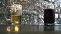 Two glass mugs with dark and light beer on the wooden table Royalty Free Stock Photo