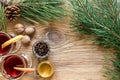 Two glass of mulled wine with cinnamon sticks, slice of oranges and apple, star anise on a wooden table Royalty Free Stock Photo