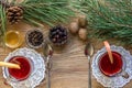 Two glass of mulled wine with cinnamon sticks, slice of oranges and apple, star anise on a wooden table Royalty Free Stock Photo