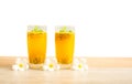 Two glass of passionfruit juice with mint and flowers on wooden table, isolated on white background, die cut with clipping path