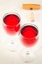 Two glass of red wine and corkscrew on white background/Two glass of red wine and corkscrew on white background. Top view Royalty Free Stock Photo