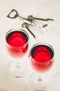Two glass of red wine and corkscrew on white background/Two glass of red wine and wooden corkscrew on white background. Top view Royalty Free Stock Photo