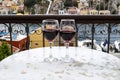 Two Glass of Red Wines on a Marble Bistro Overlooking the Main Port of Symi Royalty Free Stock Photo