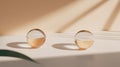 Two glass spheres with white and orange layers, casting shadows on a white surface. Royalty Free Stock Photo