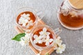 Two glass transparent cups with aromatic jasmine tea on a wooden tray . tea teapot with freshly brewed tea. tea time Royalty Free Stock Photo