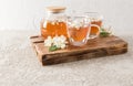 Two glass transparent cups with aromatic jasmine tea on a wooden tray . tea teapot with freshly brewed tea. tea time Royalty Free Stock Photo