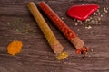 two glass tubes with spicy powders and a stone Royalty Free Stock Photo