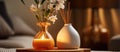 Two glass vases with orange flowers and candles on a table Royalty Free Stock Photo