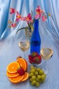 Two glass of white wine and blue bottle with orchid Royalty Free Stock Photo