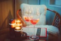 Two glass wine glasses with alcohol and lighted candles. Royalty Free Stock Photo