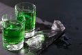 Two glasses of absinthe and melted ice cubes Royalty Free Stock Photo