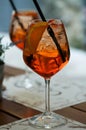 Two glasses of aperol spritz or campari orange cocktail with orange slice and ice on a restaurant table. Holiday concept. Live Royalty Free Stock Photo