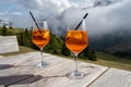 Two Glasses of Aperol Spritz cocktail served at a small cafe in Italian Dolomites Mountains Royalty Free Stock Photo