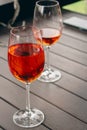 Two glasses of Aperol Spritz cocktail. Wineglasses with rose wine. Outdoor bar. Sidewalk cafe table. Alcohol party. Royalty Free Stock Photo