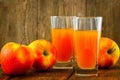 Two glasses of apple juice and apples on wooden Royalty Free Stock Photo