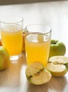 Two glasses of apple juice, fresh apples on the table, fruit and Royalty Free Stock Photo