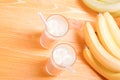 Two glasses of banana juice on the table next to a yellow ripe b Royalty Free Stock Photo