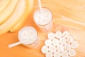 Two glasses of banana juice on the table next to a yellow ripe b Royalty Free Stock Photo