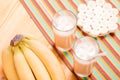Two glasses of banana juice on the table next to a yellow ripe b Royalty Free Stock Photo