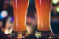 Two Glasses of Beer on a bar table. Beer Tap on background. Royalty Free Stock Photo