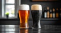 Two glasses of beer, one brown and one light brown, sit on a table Royalty Free Stock Photo
