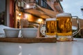 Two glasses of beer with reflection of street lights