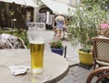 Two glasses of beer stand on a table in a street cafe with bills for payment, selective focus Royalty Free Stock Photo