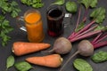 Two glasses of beetroot and carrot juice. Root vegetables of beets and carrots, parsley and basil Royalty Free Stock Photo