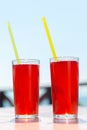 Two glasses with berry juice and strawberries on the table of a street Royalty Free Stock Photo