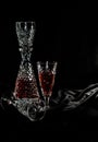 Two glasses on black velvet, red alcohol. Royalty Free Stock Photo