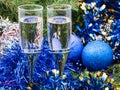 Two glasses with blue Xmas decorations and tree 3 Royalty Free Stock Photo