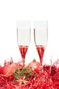 Two glasses of champagne and angel figure at red Royalty Free Stock Photo