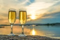 Two glasses with champagne on the background of the sunset, in nature, outdoors Royalty Free Stock Photo