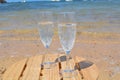 Two Glasses Of Champagne On The Beach With Sea Bac Royalty Free Stock Photo