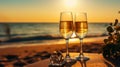 Two glasses of champagne on the beach at sunset with sea on the background. Romantic evening by sea Royalty Free Stock Photo