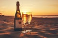 Two glasses of champagne on the beach at sunset or sunrise. Concept of celebration, love and romantic date, Champagne bottle and Royalty Free Stock Photo