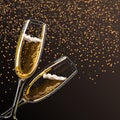 Two glasses with champagne on a black background with sparks.