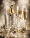 Two glasses of champagne with bottle in cooler in the background Royalty Free Stock Photo
