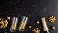 Two glasses of champagne and bottle with golden confetti, glitter, serpentine and lights. Christmas or New Year Eve celebration Royalty Free Stock Photo