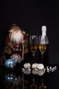 Two glasses champagne, bottle, Santa Claus and Christmas decoration Royalty Free Stock Photo