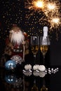 Two glasses champagne, bottle, Santa Claus and Christmas decoration Royalty Free Stock Photo