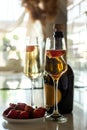 two glasses with champagne, bottle and strawberries. light and shadow, silhouette. romantic evening Royalty Free Stock Photo