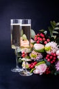 Two Glasses Of Champagne And Bouquet Of Pink Flowers