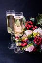 Two Glasses Of Champagne And Bouquet Of Pink Flowers