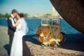 two glasses with champagne and a bouquet of roses on a background of loving couples Royalty Free Stock Photo