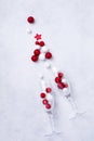 Two glasses for champagne and Christmas champagne bottle with sprinkles in the form of Christmas tree made of red and white toys b Royalty Free Stock Photo