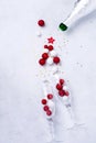 Two glasses for champagne and Christmas champagne bottle with sprinkles in the form of Christmas tree made of red and white toys b Royalty Free Stock Photo